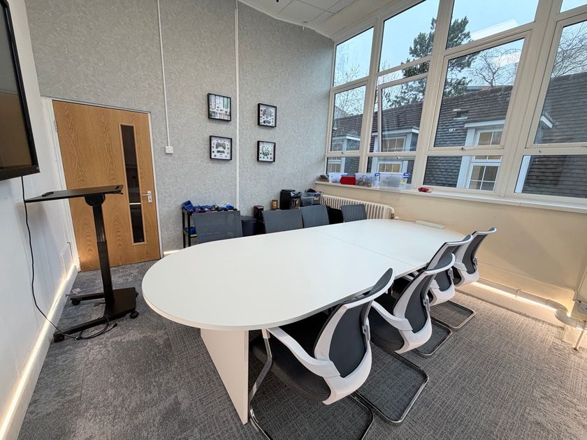 The multi-function Board Room set up with laptops and a conference table
