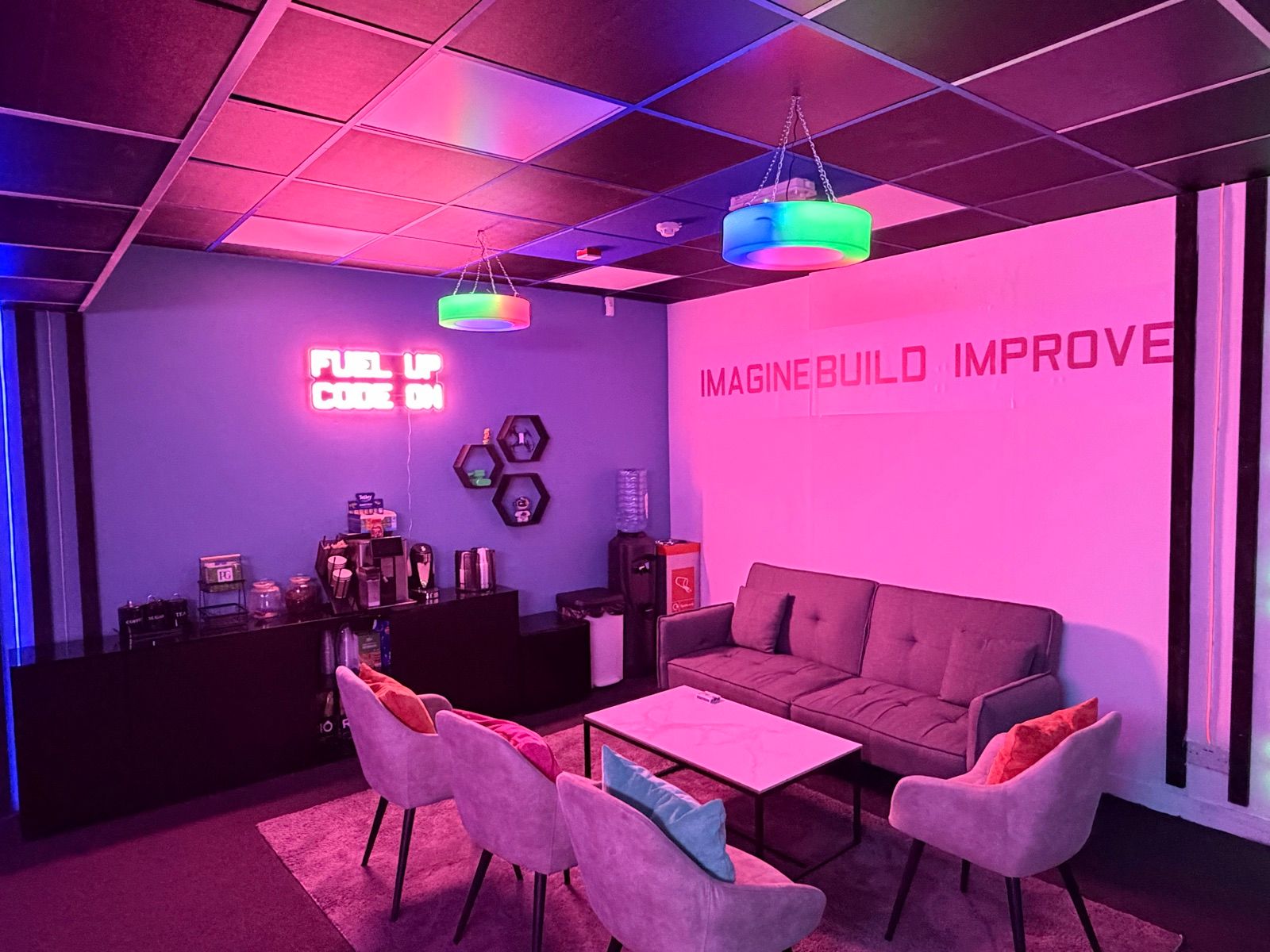 The parents’ coffee corner under the Imagine, Build, Improve wall