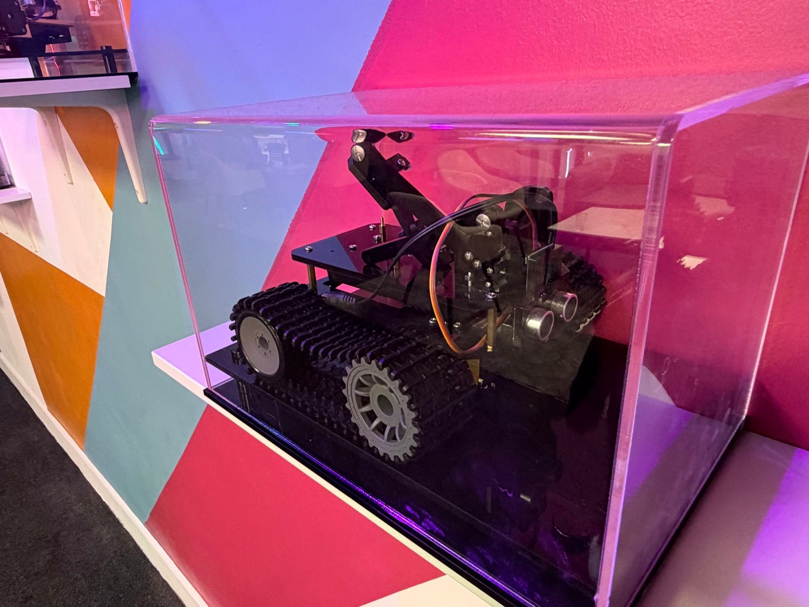 A robot in a display case on the feature wall
