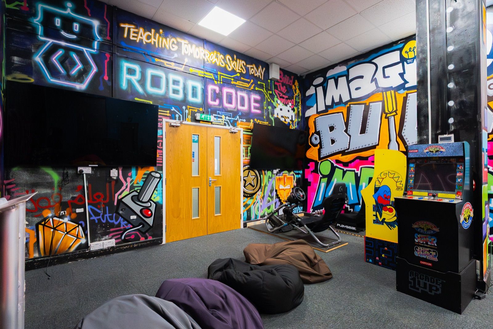 The arcade and social area at the Robocode Solihull centre, with a full-wall graffiti mural