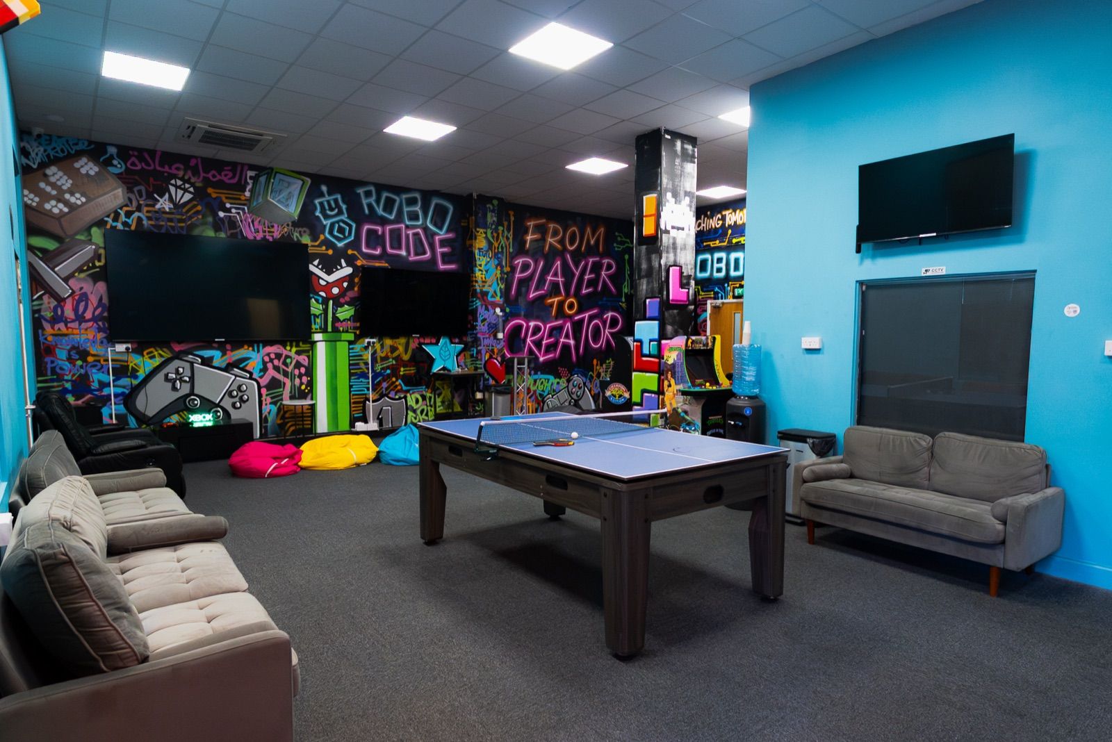 The social space with a pool table and graffiti wall