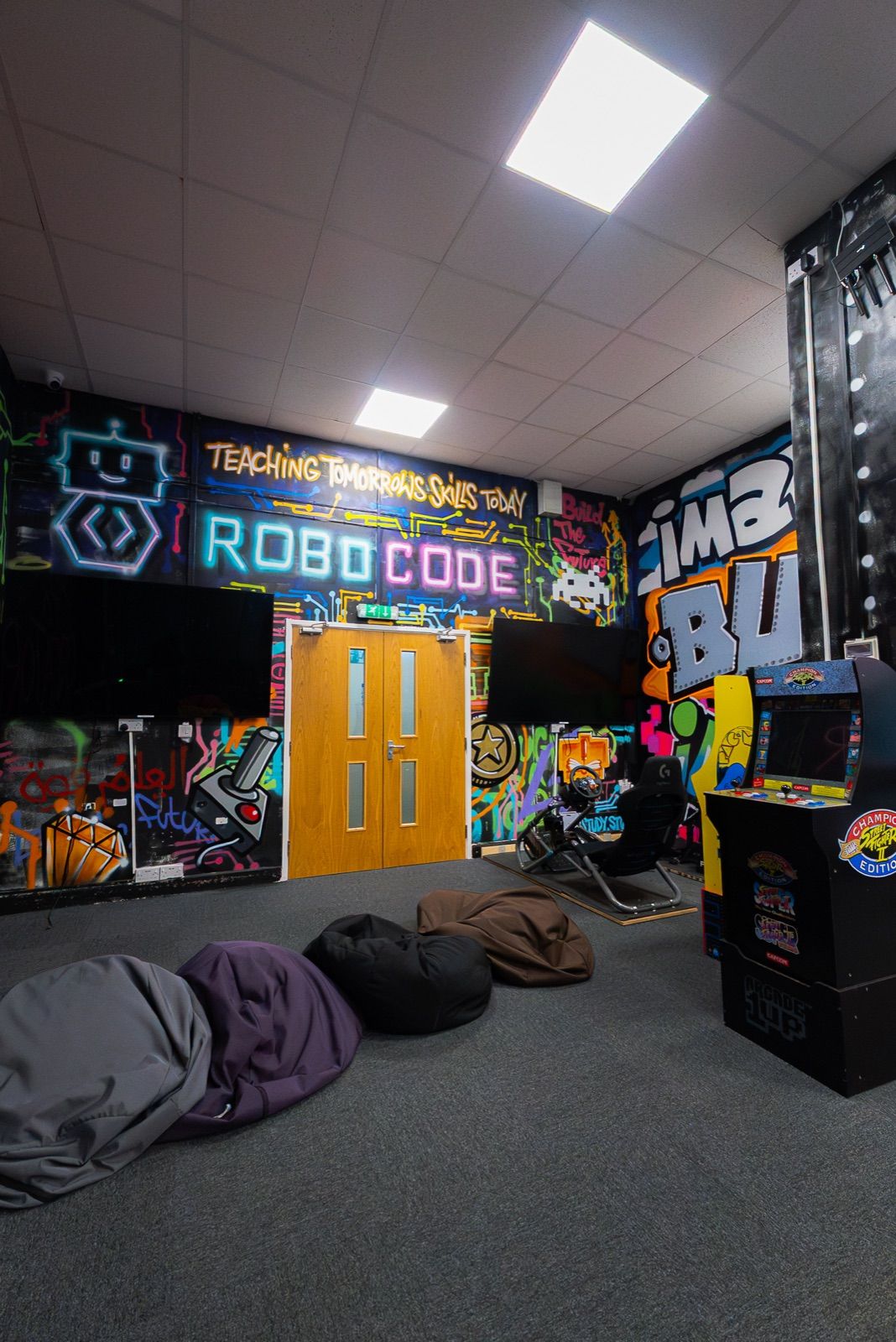 The arcade and graffiti wall in the social area