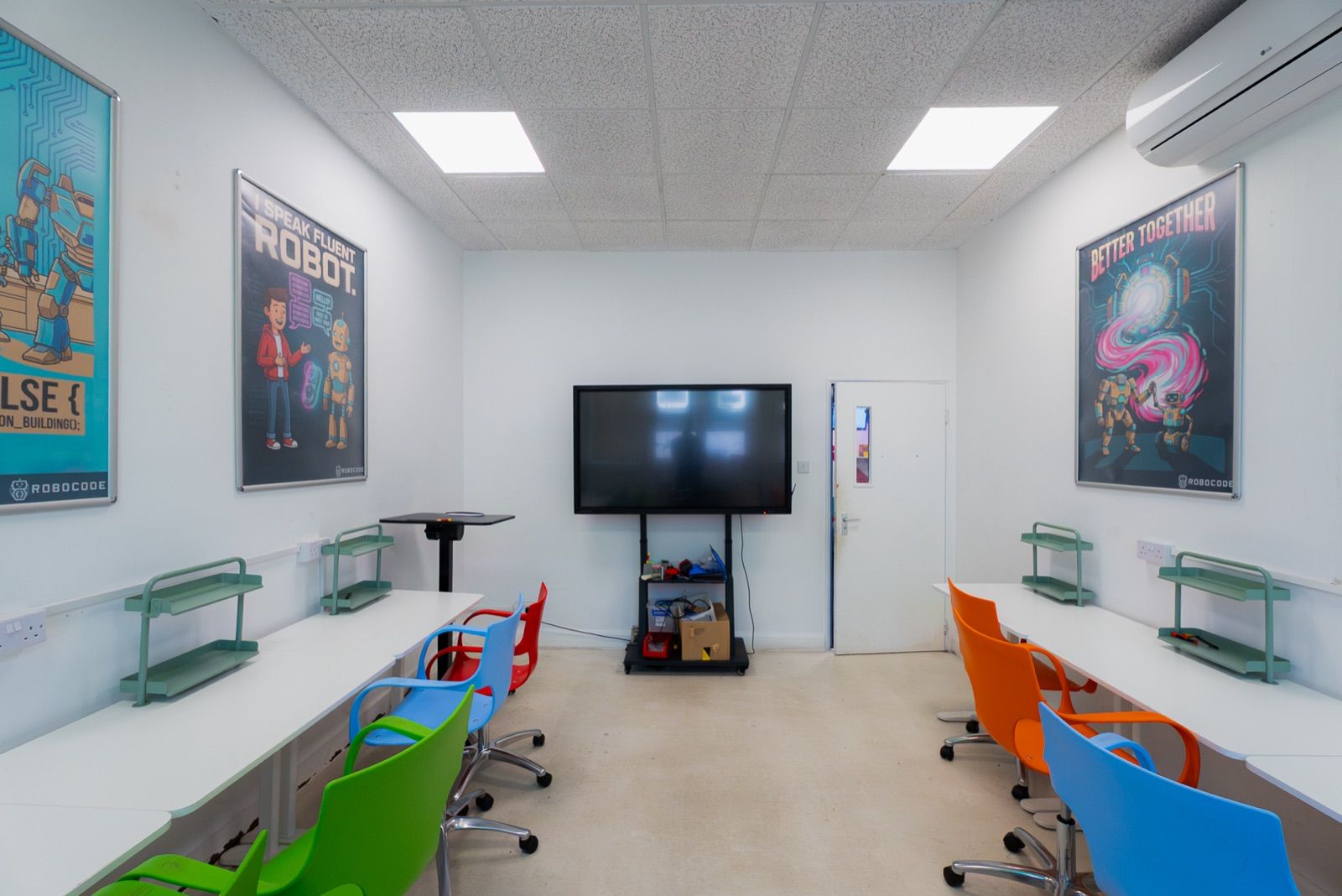 A robotics Studio Lab with a smart display and colour-coded chairs