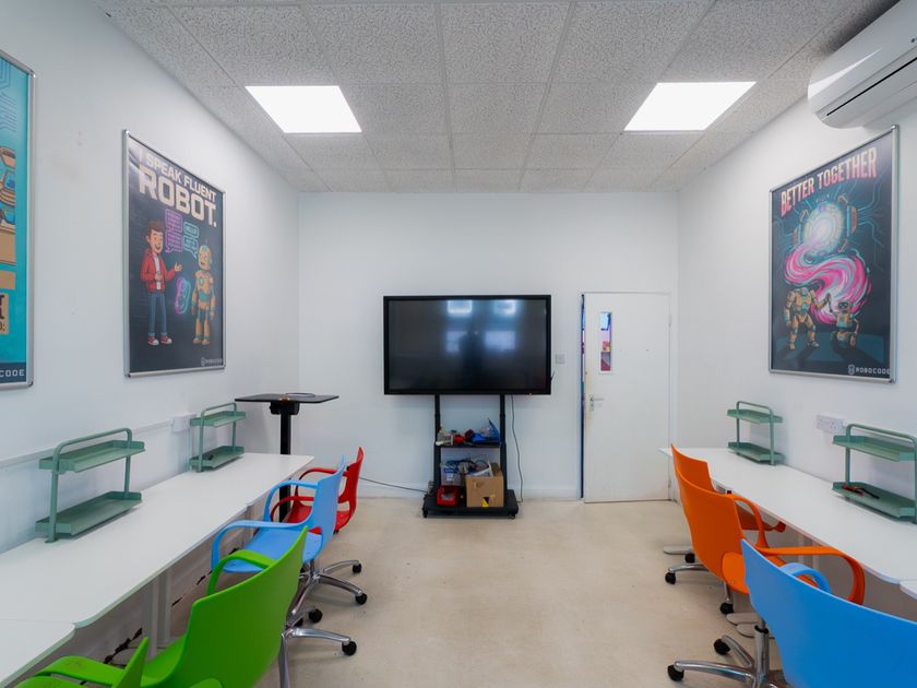 A robotics Studio Lab with a smart display and colour-coded chairs