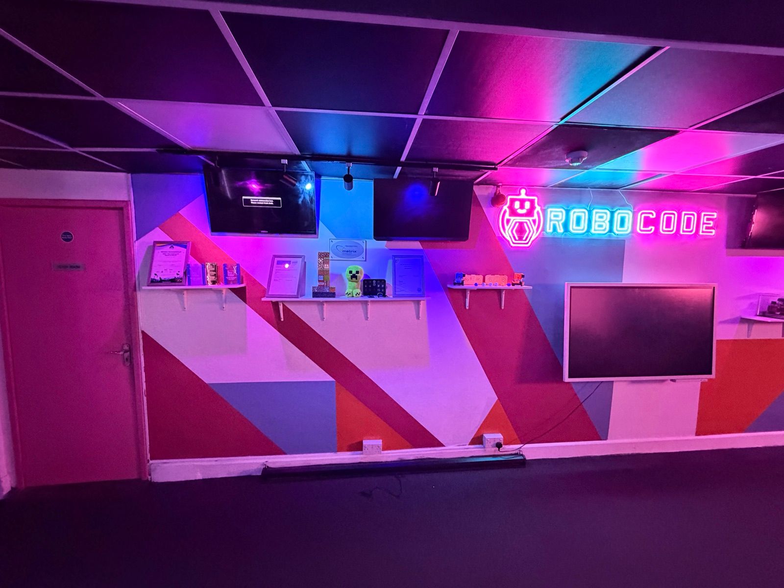 The neon-lit seating area under the Robocode sign