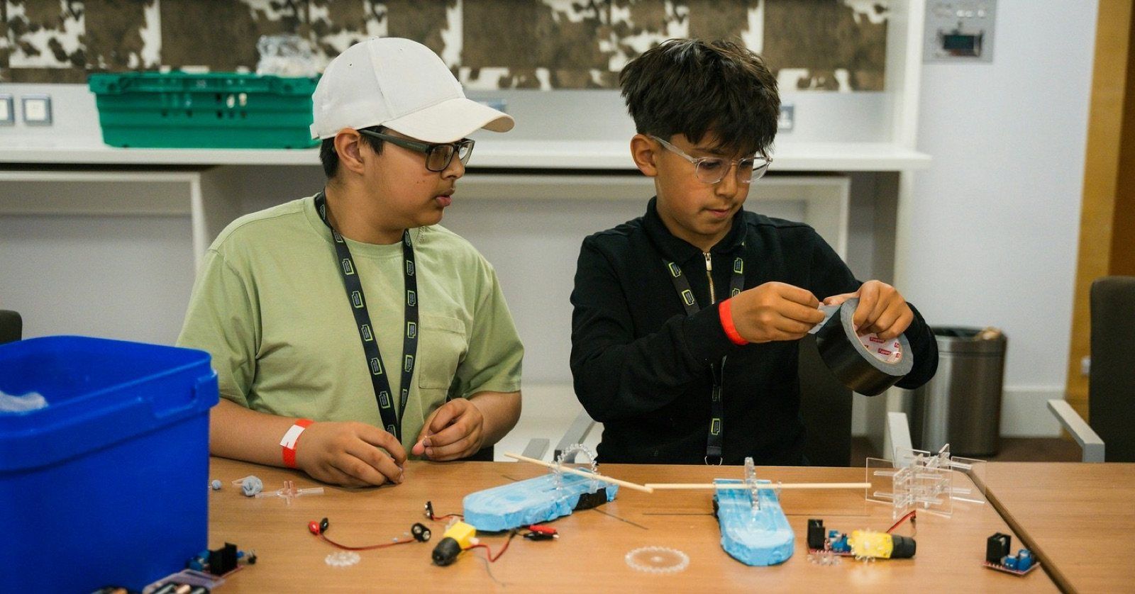 Two Robocoders building a model boat together