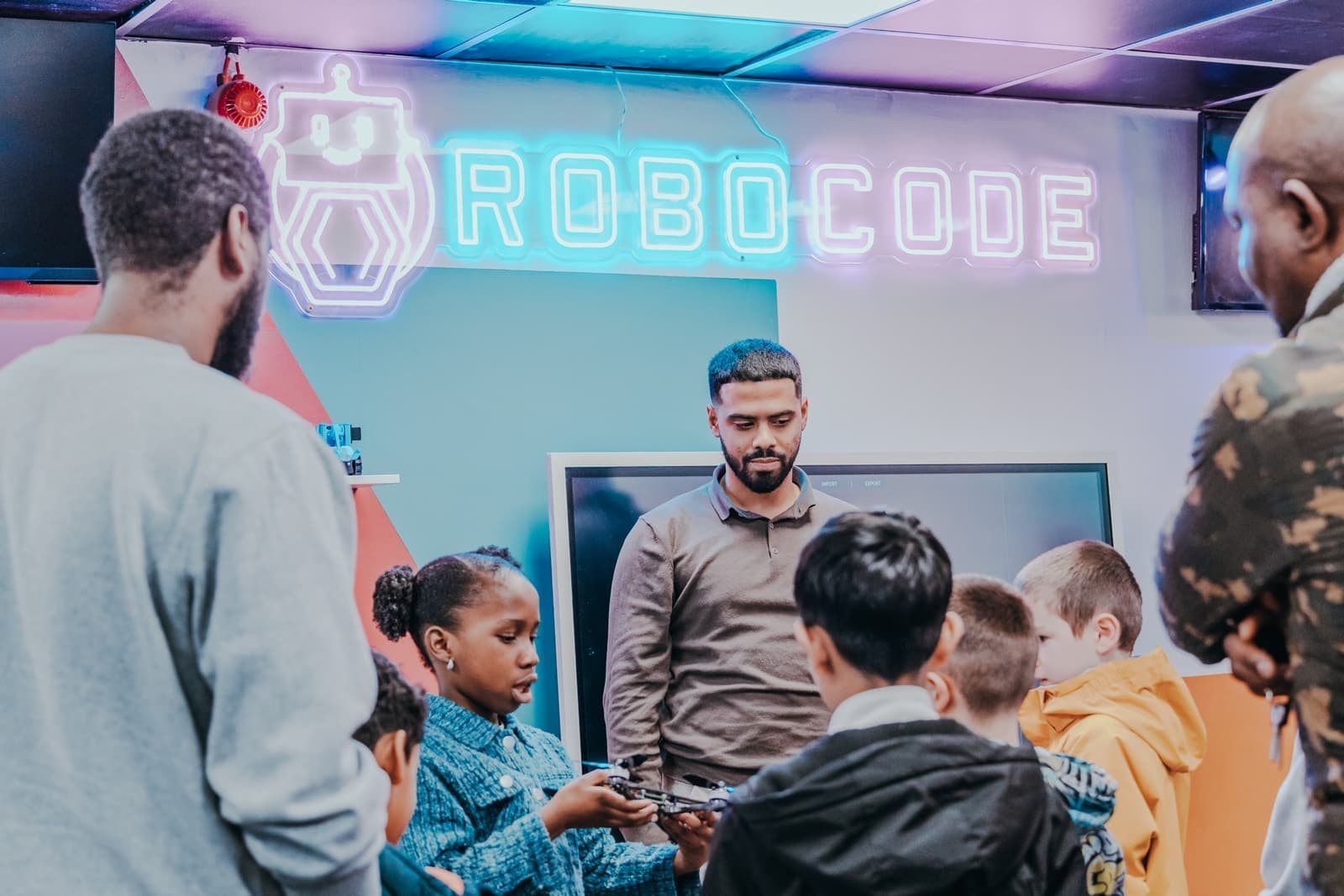 A Mentor showing a group of Robocoders the drone they are building