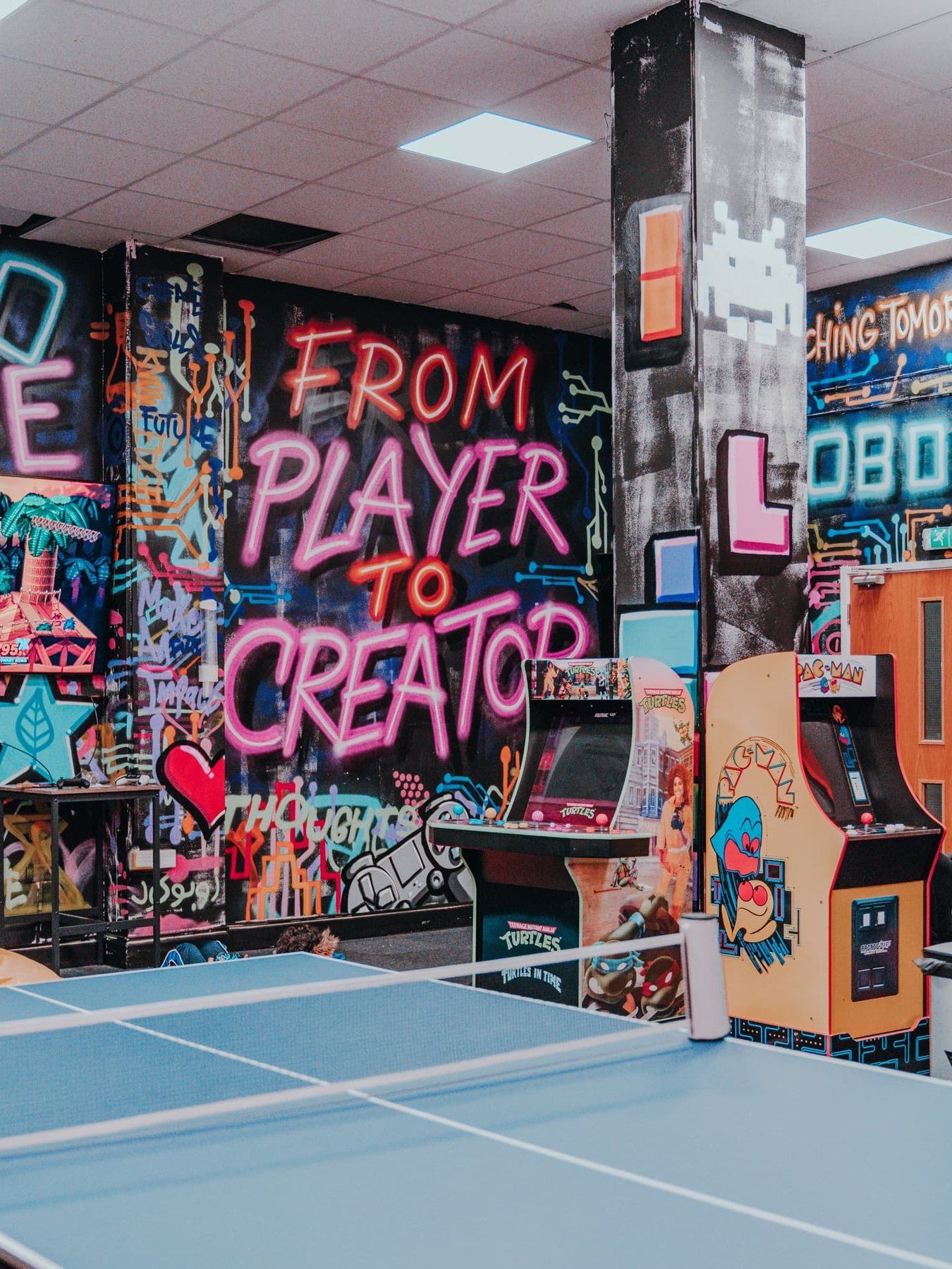 The arcade and graffiti wall inside a Robocode centre