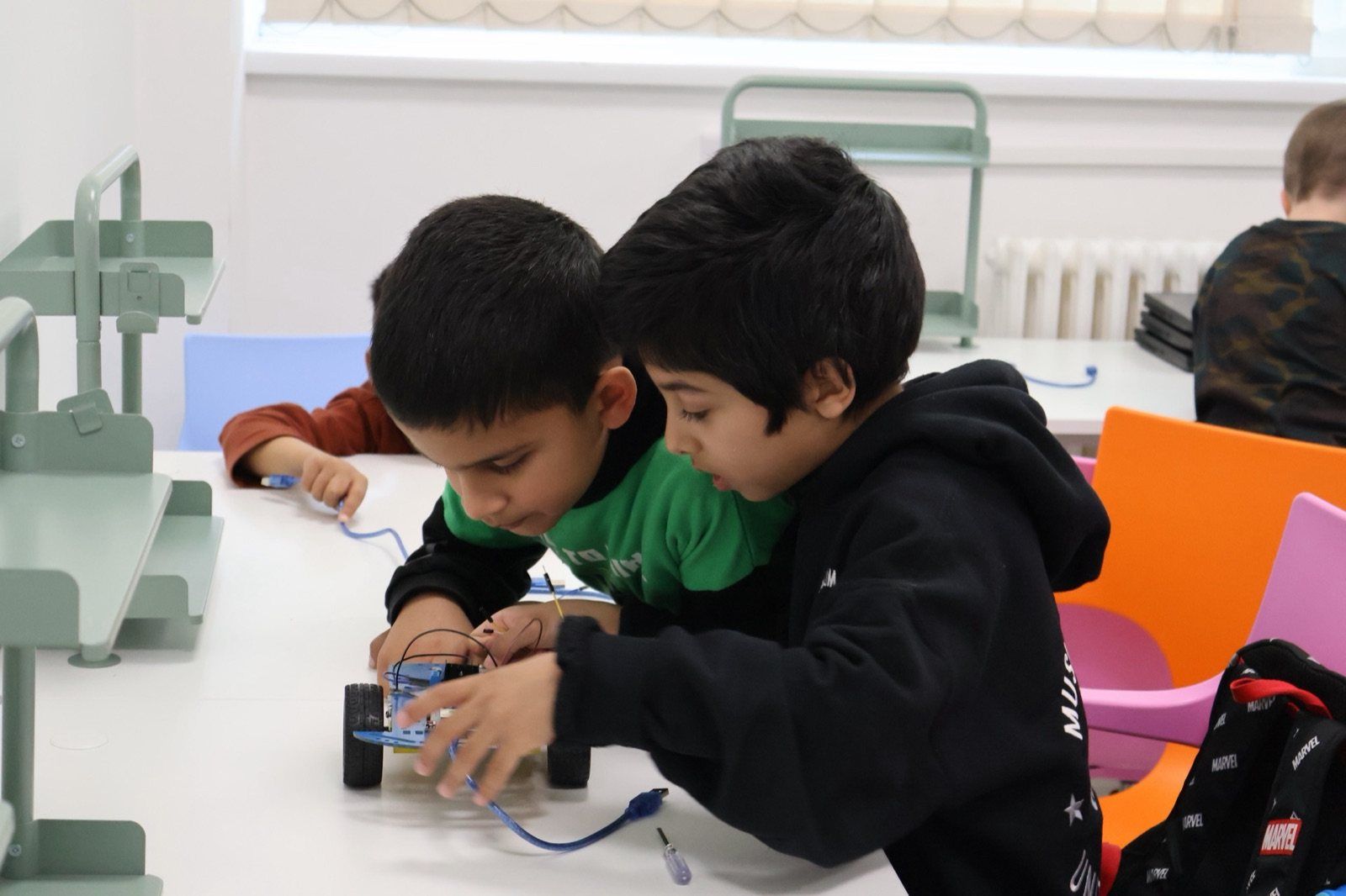 Two Robocoders building a robot together