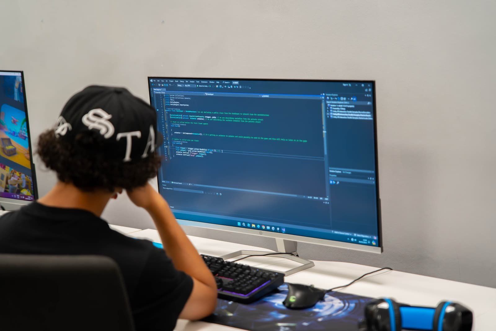 A Robocoder writing code on a large screen