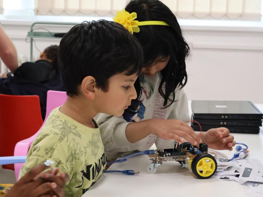 Robocoders building a robot car together