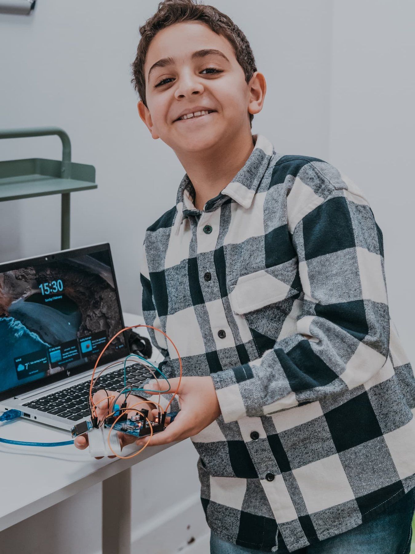 A Robocoder programming his robot build on a laptop