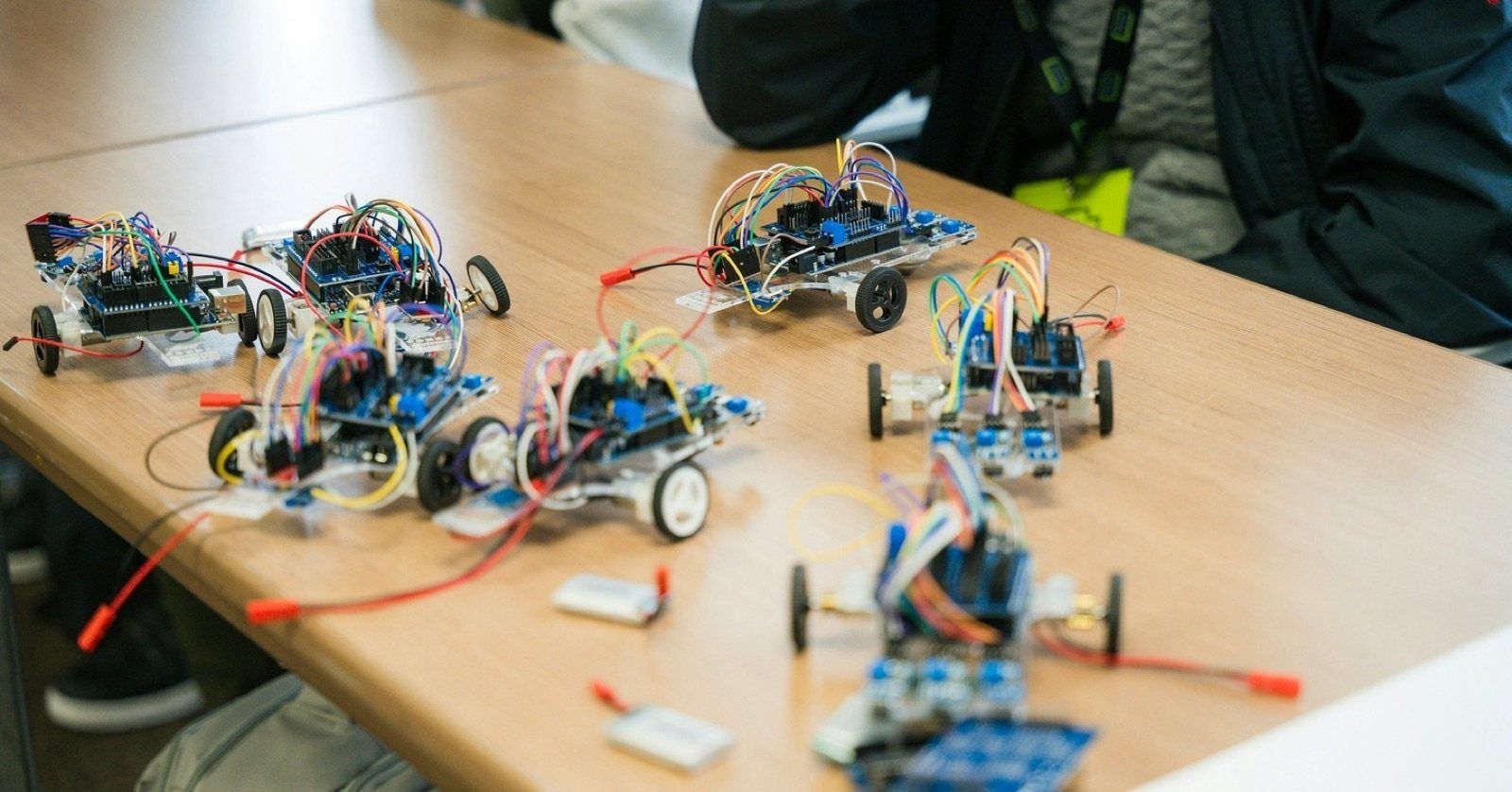 A table of robot car kits, built and ready to run