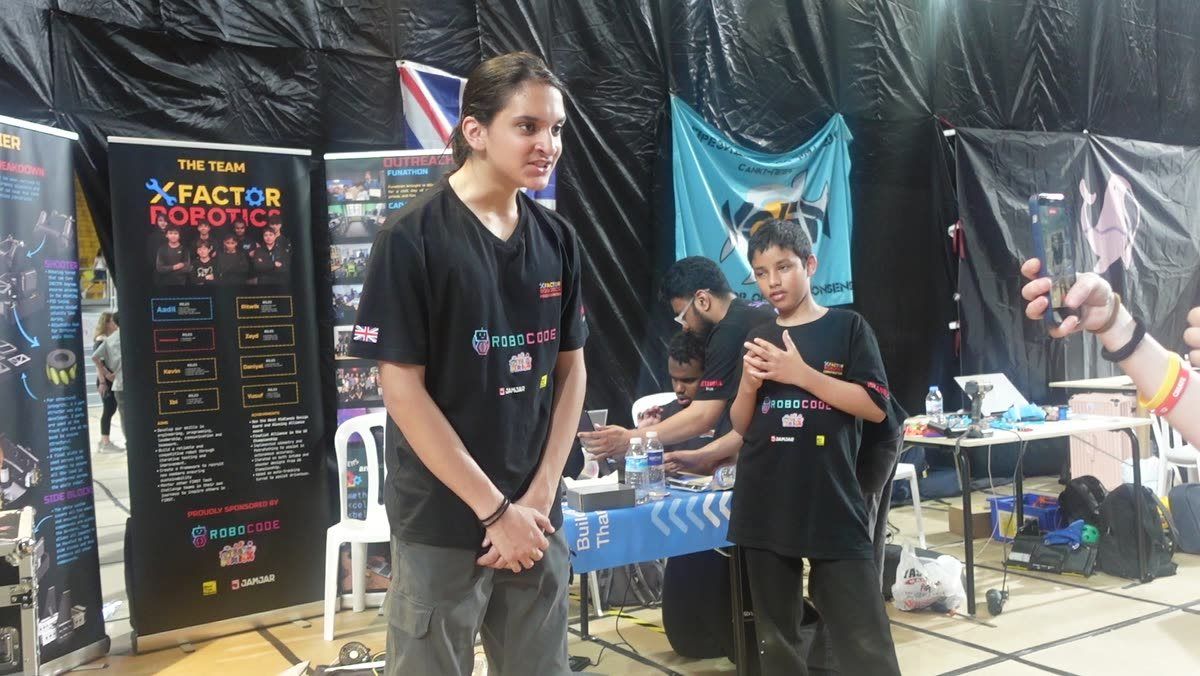 A Robocoder presenting his team's work at a robotics competition