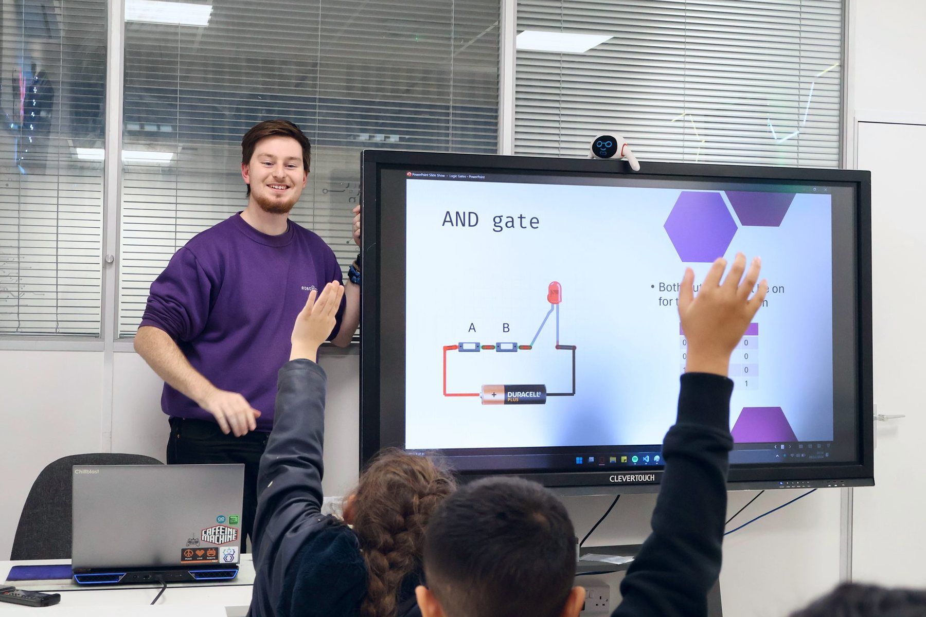A Mentor teaching logic gates as Robocoders put their hands up