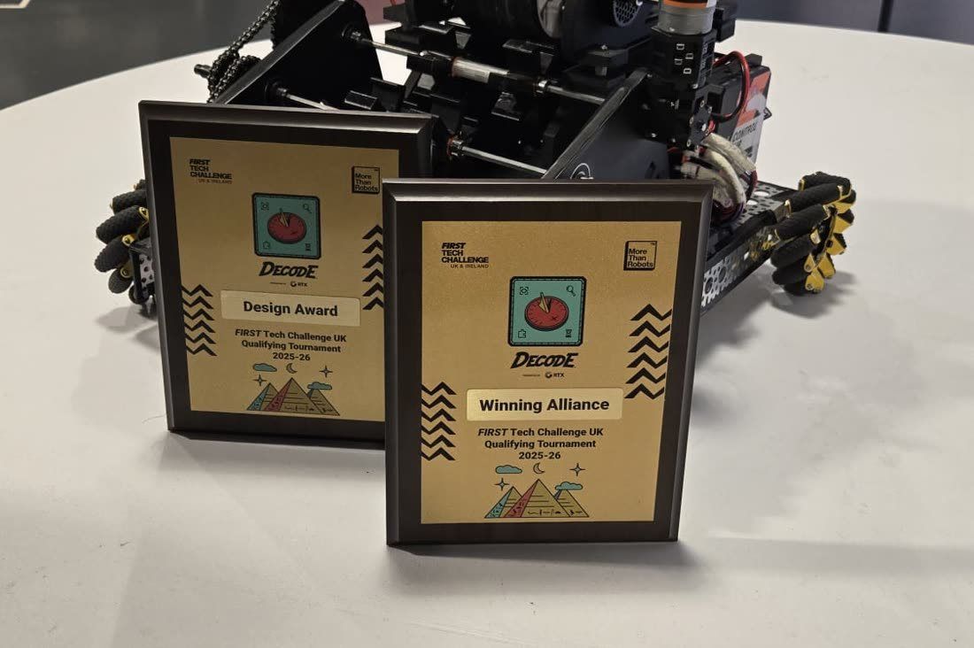 Two FIRST Tech Challenge award plaques in front of a competition robot