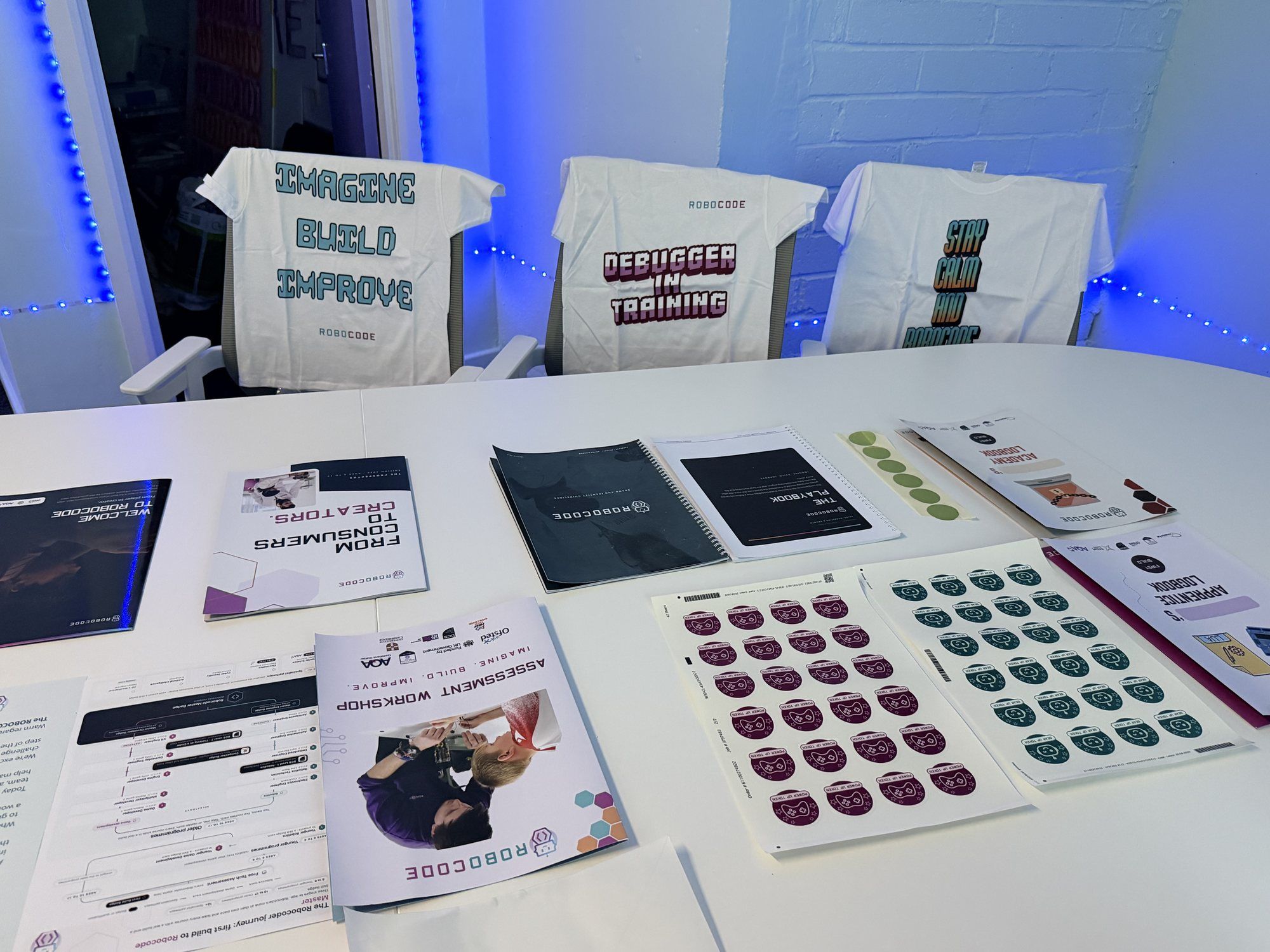 Robocode course materials, logbooks and kit laid out on a table
